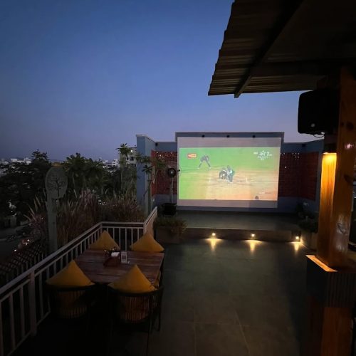 Guests watching a cricket match on the big screen at Cosmo Bar & Bistro, Udaipur